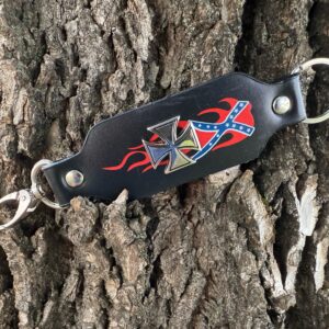 Confederate-themed leather keychain with Maltese cross, flame design, and Rebel flag overlay, displayed on rugged tree bark background.